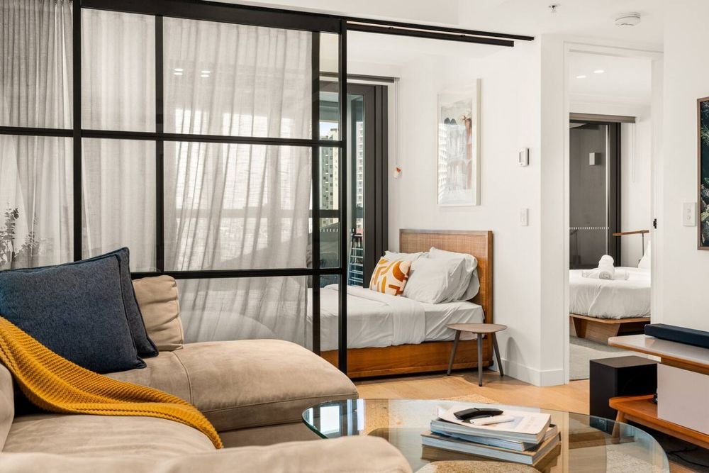 Lounge looking through the glass partition to the main bedroom